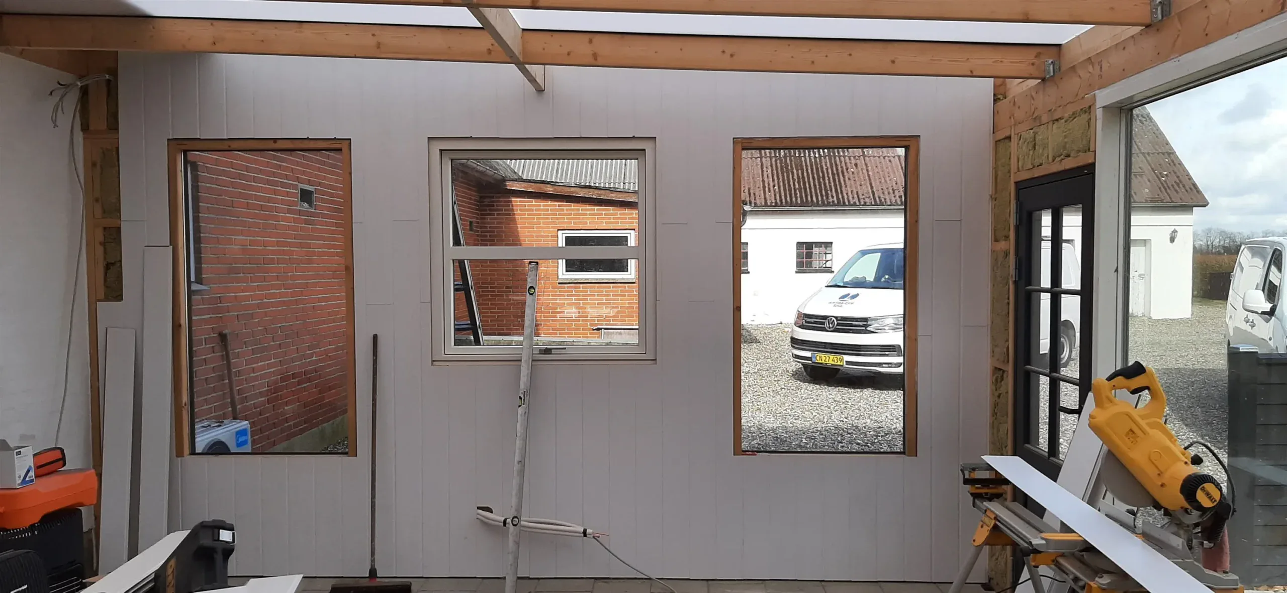 Modulbyggeri i træ til hjemmet med store vinduer og moderne design.